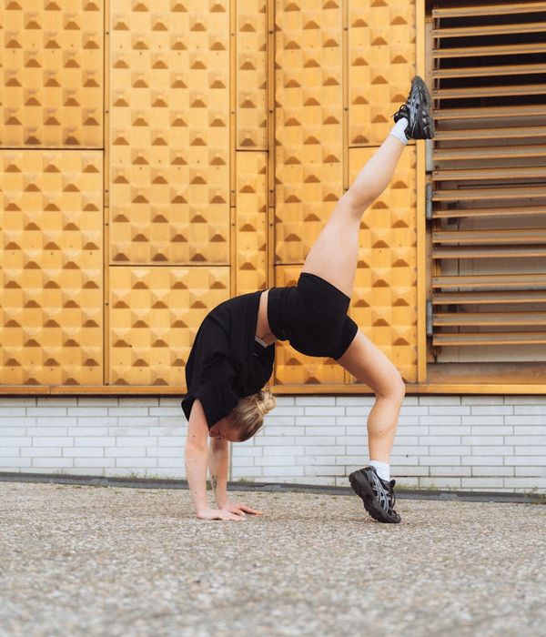 Athlete performing a dynamic yoga pose, highlighting strength and flexibility.